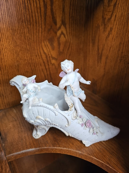 Antique German Bisque Angel figurine on a victorian shoe